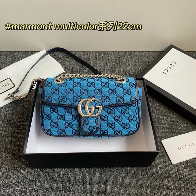 Gucci Small GG Marmont shoulder bag in sky blue bouclé with the signature GG Supreme embroidery.