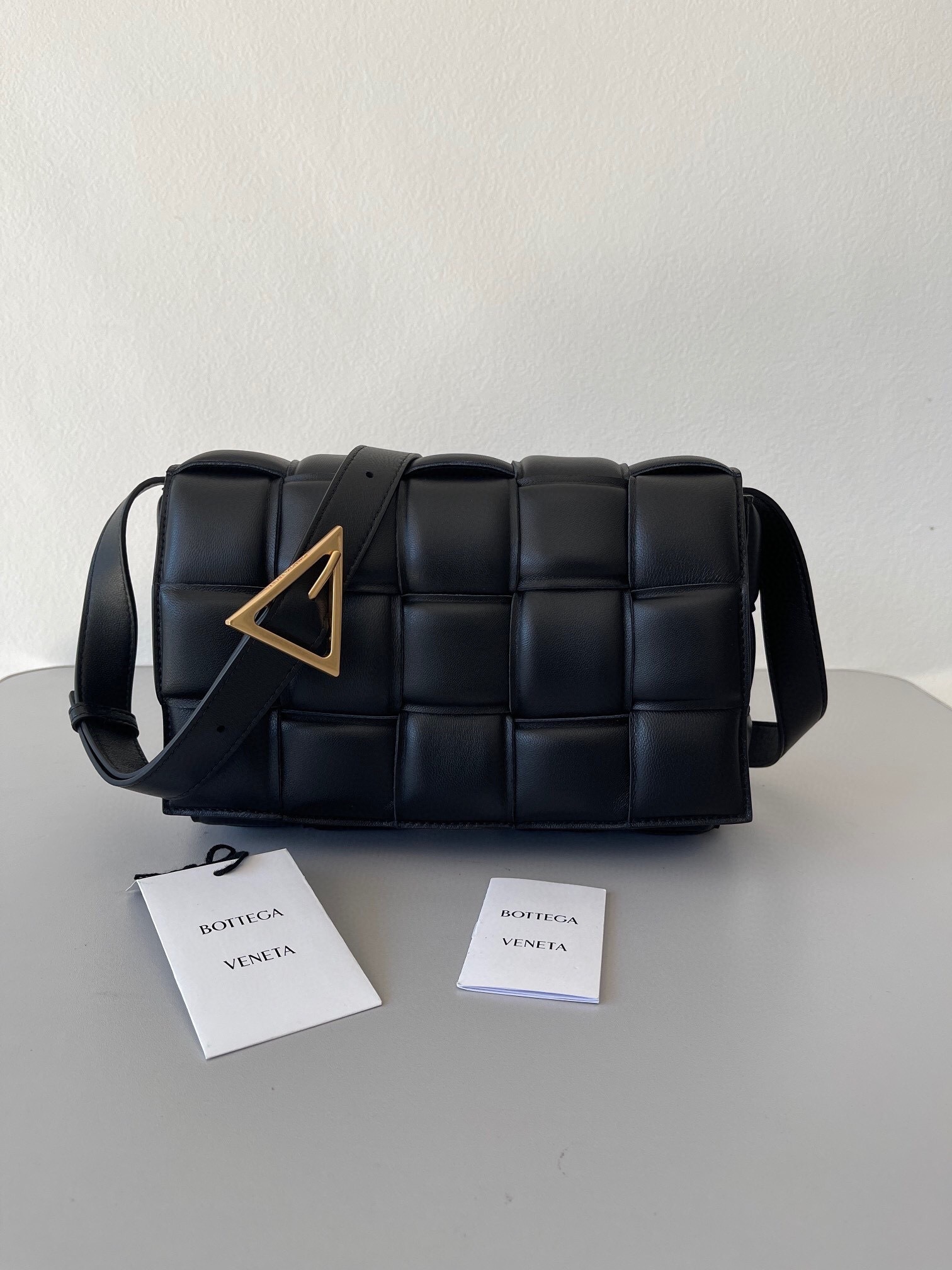 Bottega Veneta Padded Cassette bag in black leather with a gold-tone buckle