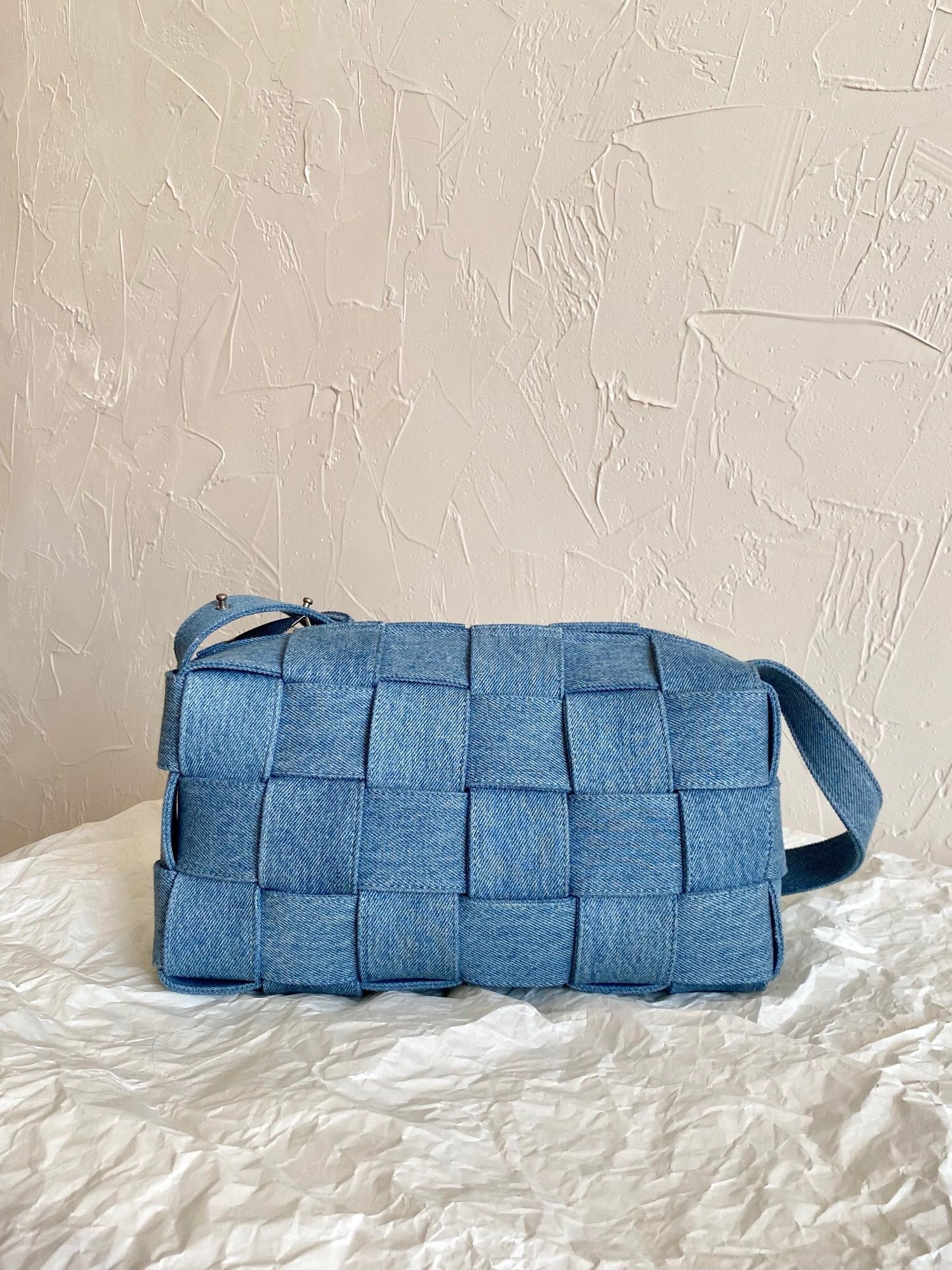Bottega Veneta Brick Cassette small denim shoulder bag with the signature oversized Intrecciato weaving