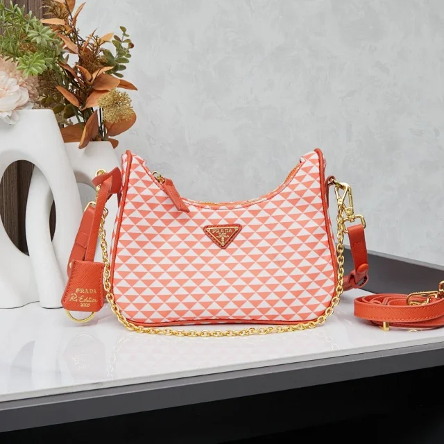 Prada Re-Edition shoulder bag with a chain strap and a geometric print