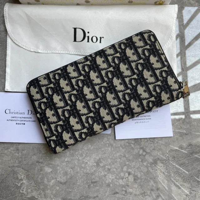 Dior Saddle Long Zipped Wallets in black grained calfskin marquetry and beige and black Dior Oblique jacquard