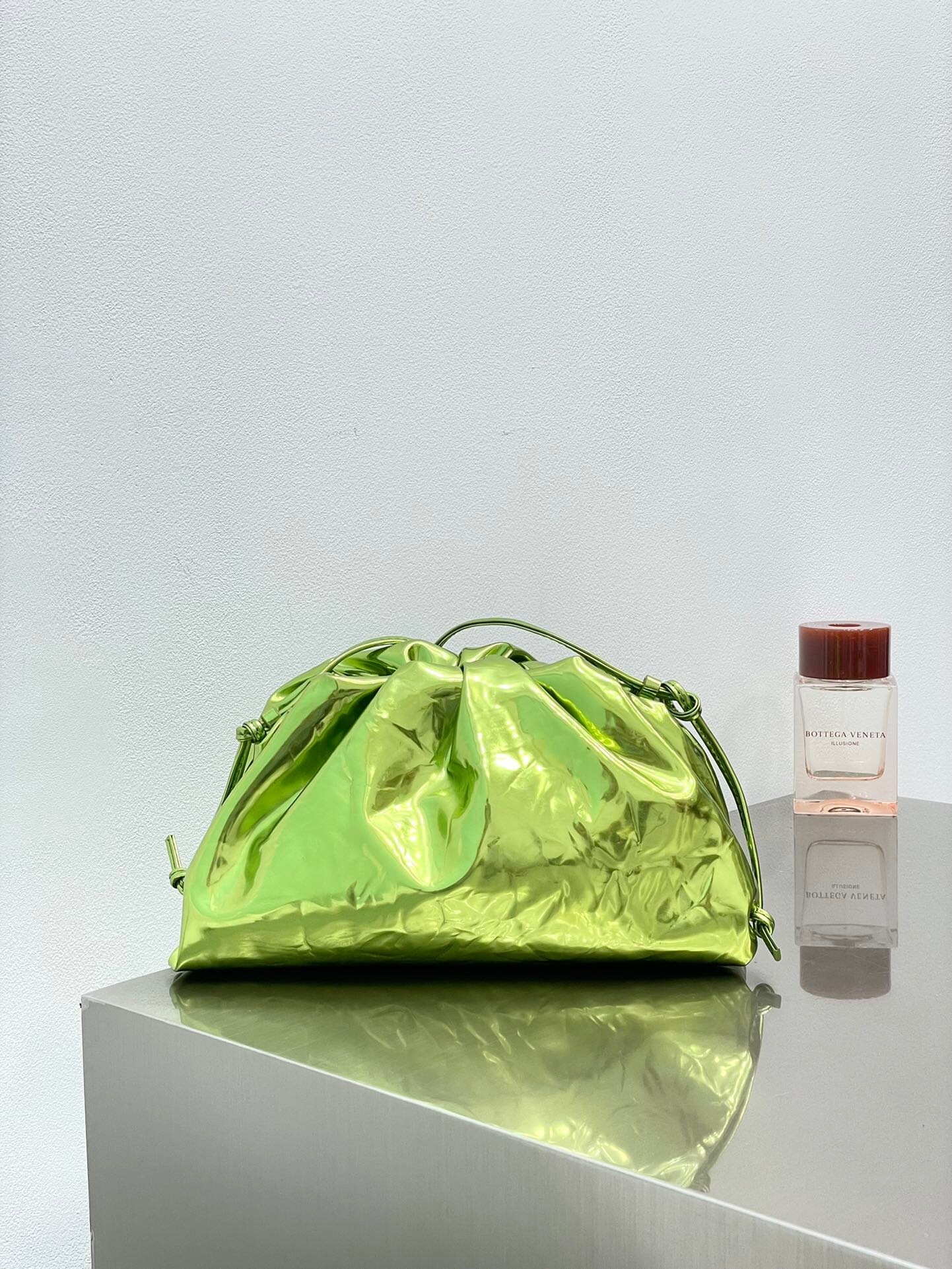 Bottega Veneta Metallic Crushed Calfskin The Mini Pouch in the color Chlorophyll.