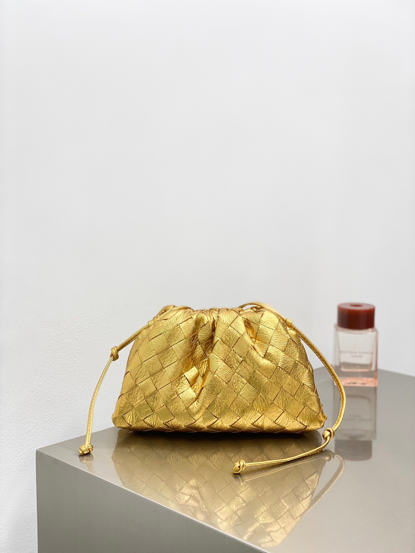 Bottega Veneta Mini Pouch bag in metallic gold leather