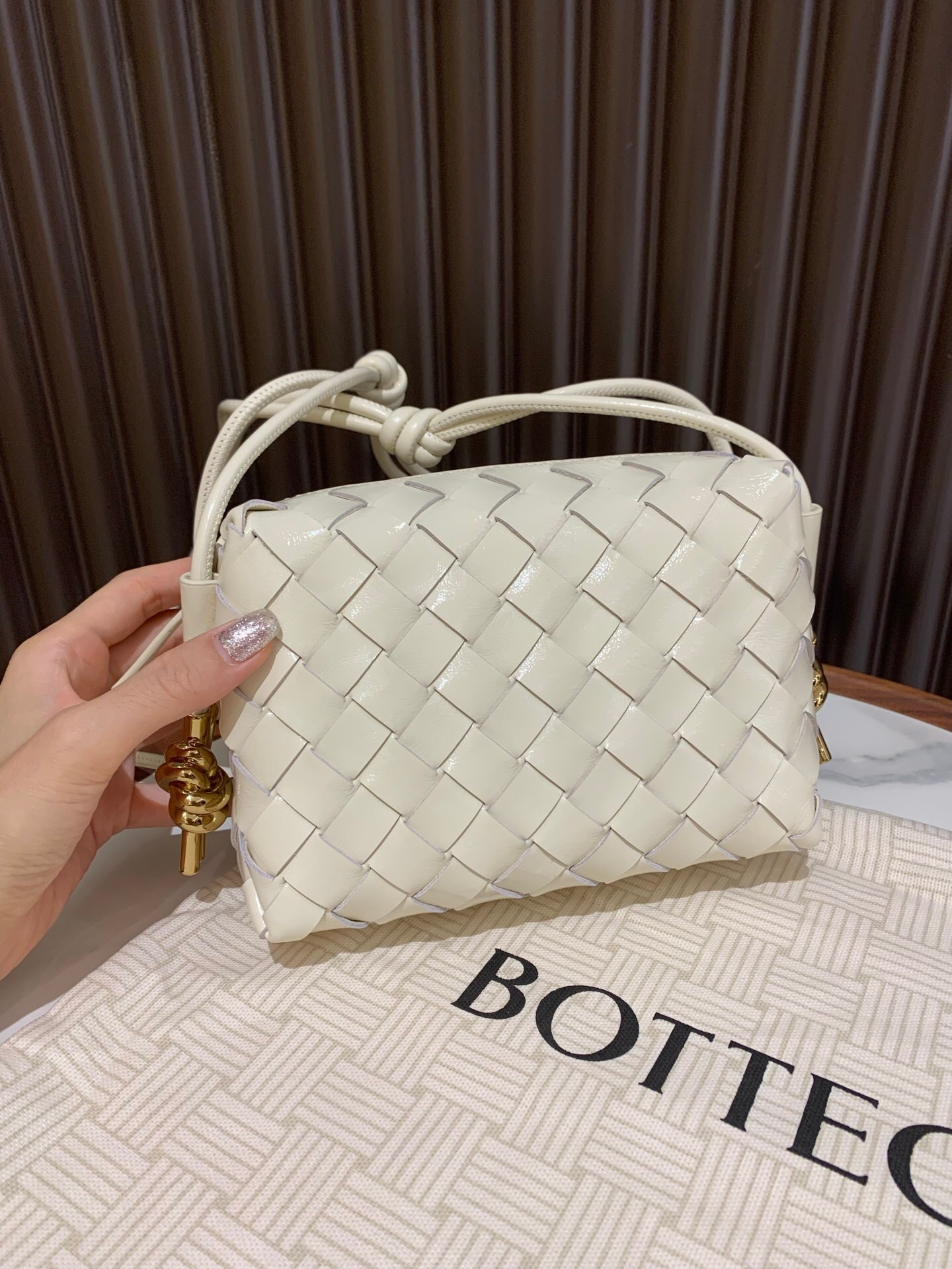 Bottega Veneta Mini Loop intrecciato leather crossbody bag in the color bone