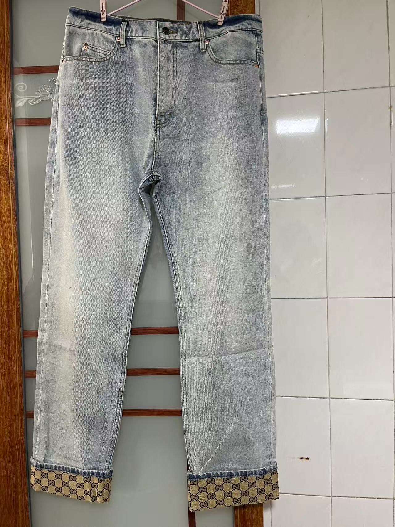 Gucci light-wash denim jeans with a monogram cuff