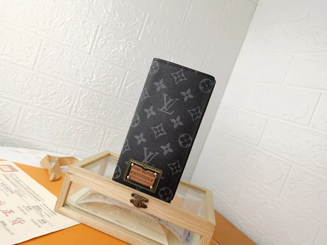LV Brazza Wallet in Monogram Shadow calf leather.