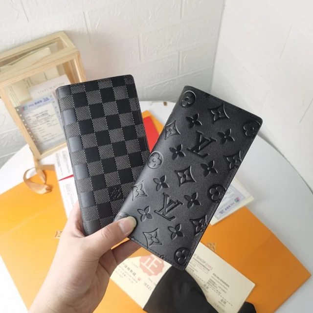 LV Brazza Wallet in both Damier Graphite canvas and black Monogram Taurillon leather.