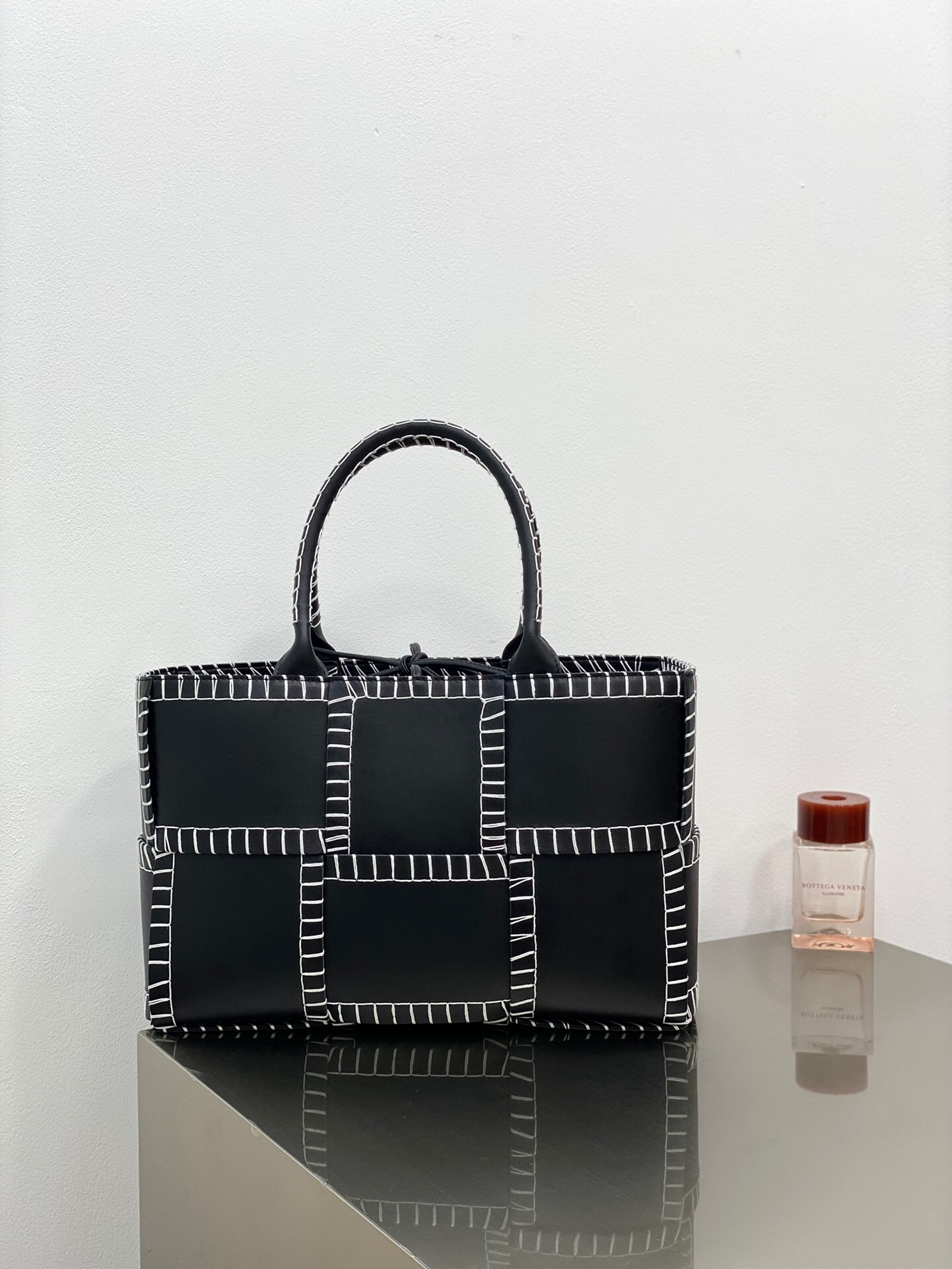 Bottega Veneta Nappa Maxi Intrecciato Overlock Stitched Small Arco Tote in black and silver tote bag