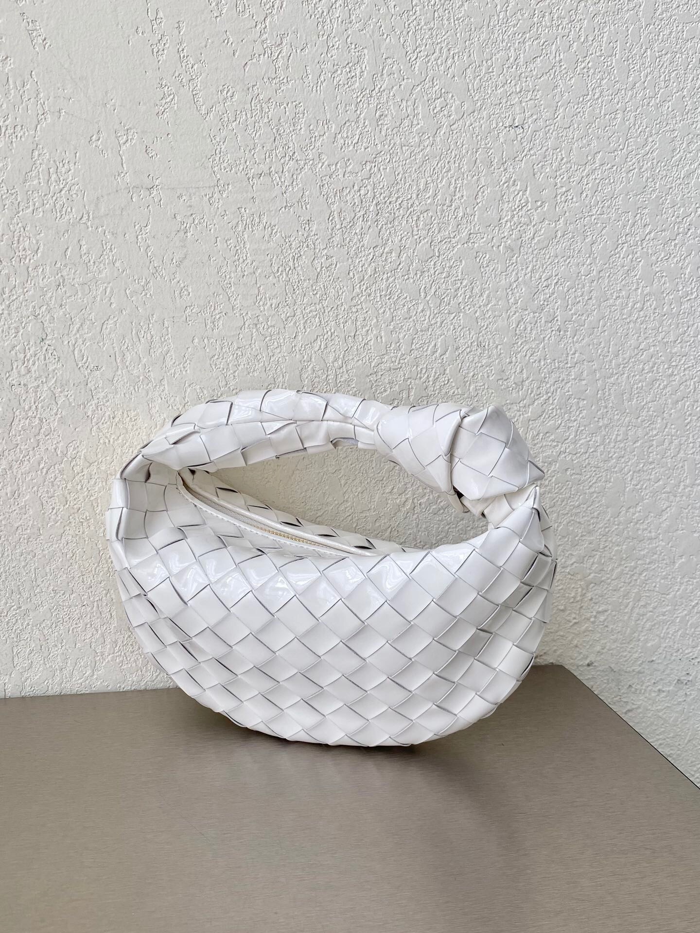 Bottega Veneta Mini Jodie handbag featuring the brand's signature intrecciato weave white tote