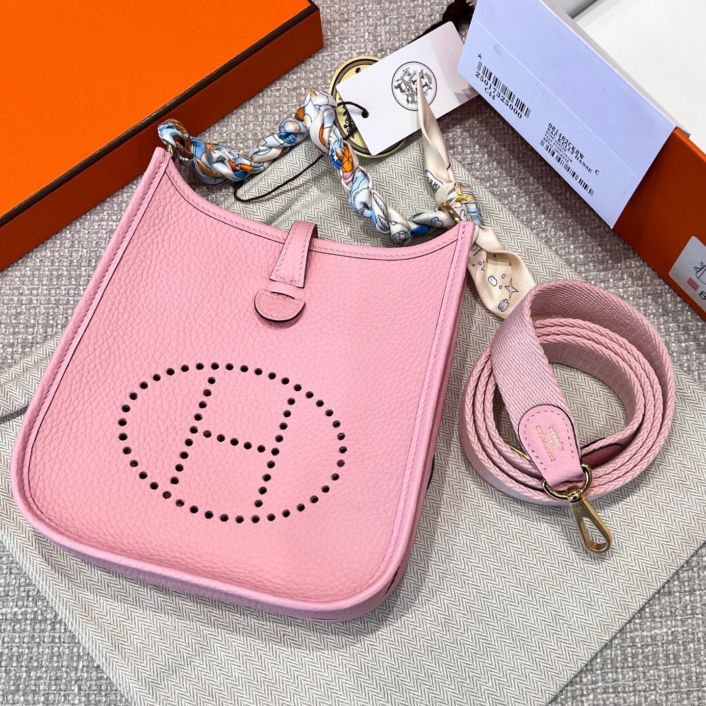Hermes Mini Evelyne 16 TPM bag in Rose Sakura leather with a multicolored strap shoulder bag