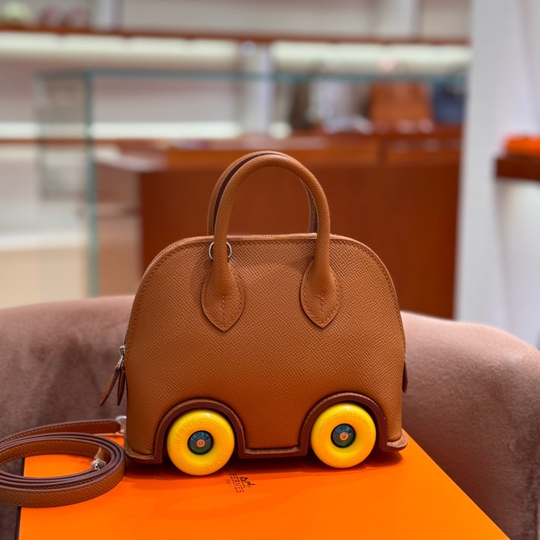 Hermes Mini 1923 Bolide On Wheels in gold epsom leather with yellow rubber wheels tote bag