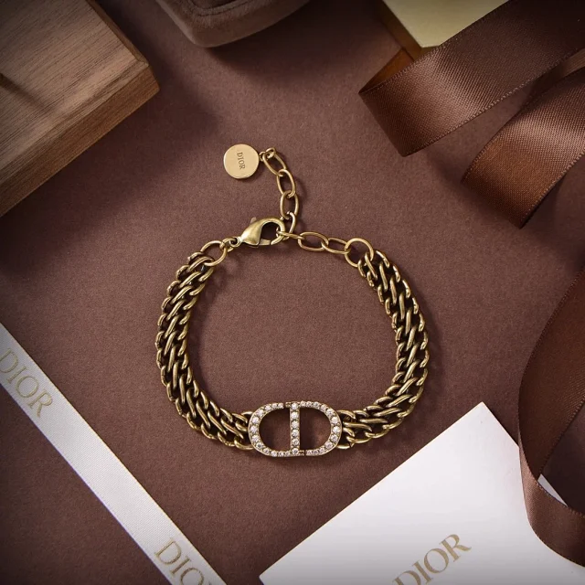 Dior CD Navy bracelet with a gold-finish metal chain and a CD signature paved with silver-tone crystals