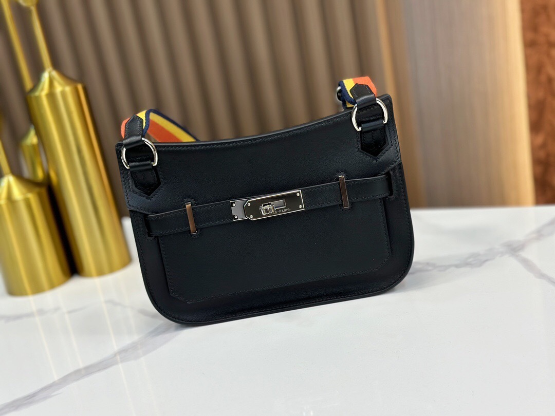 Hermes Mini Jypsière shoulder bag in black Evergrain leather with a palladium-plated hardware and a striped canvas strap