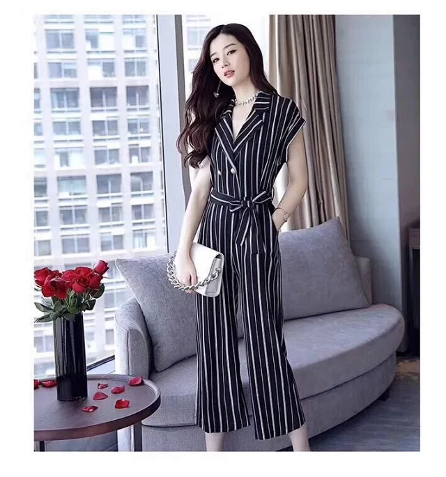 Dior navy and white striped jumpsuit with a belted waist and a V-neck collar