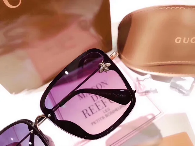Gucci sunglasses with a bee emblem on the frame