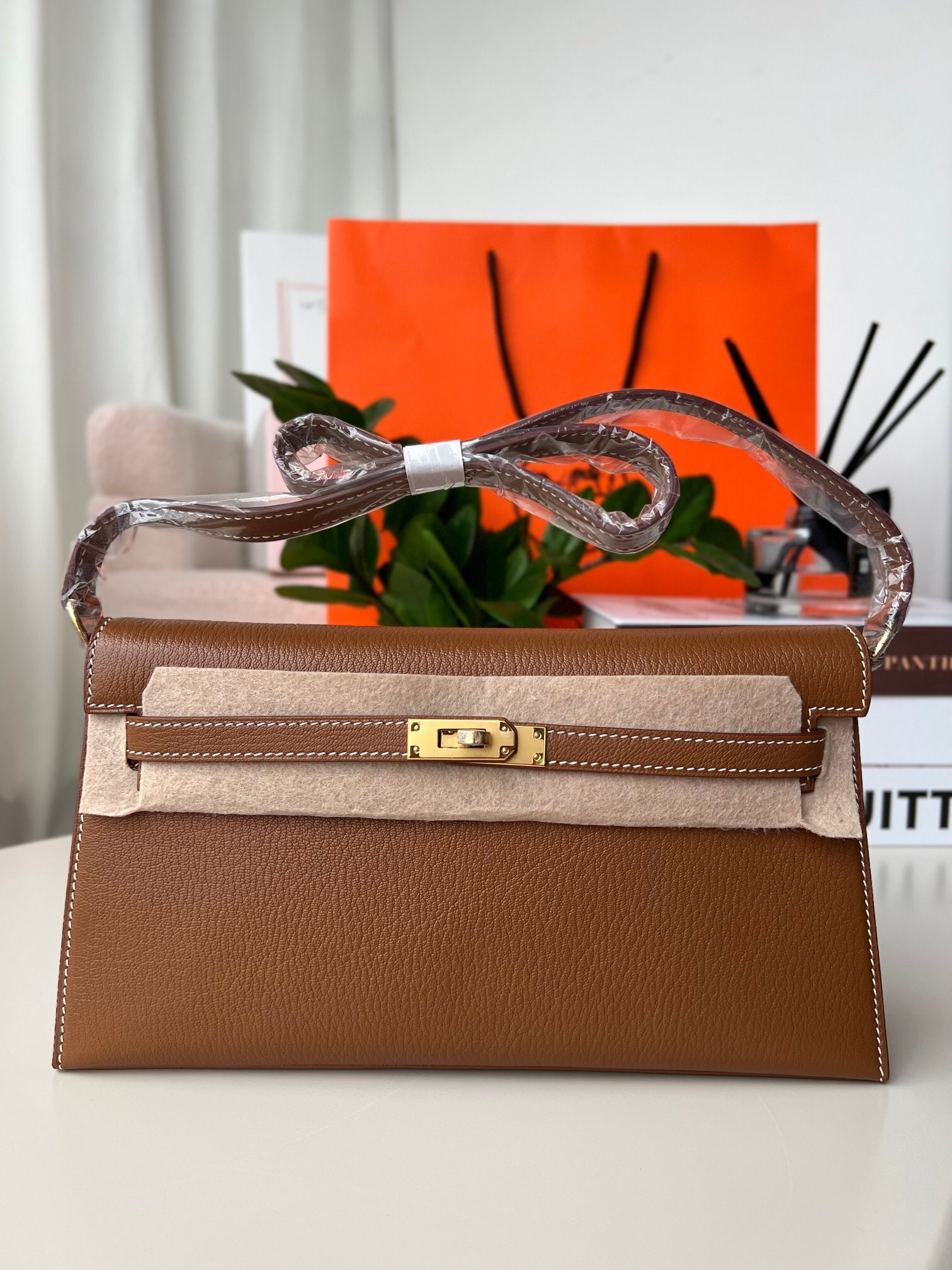 Hermes Kelly Classique To Go wallet in a brown leather