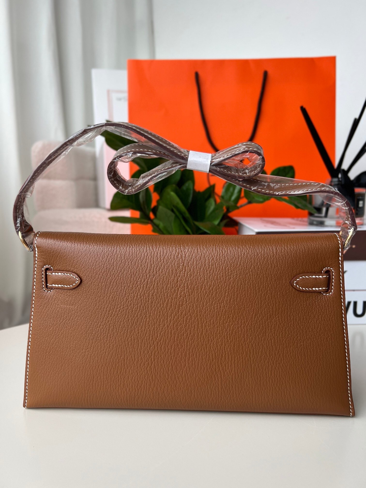 Hermes Kelly Classique To Go wallet in a brown leather