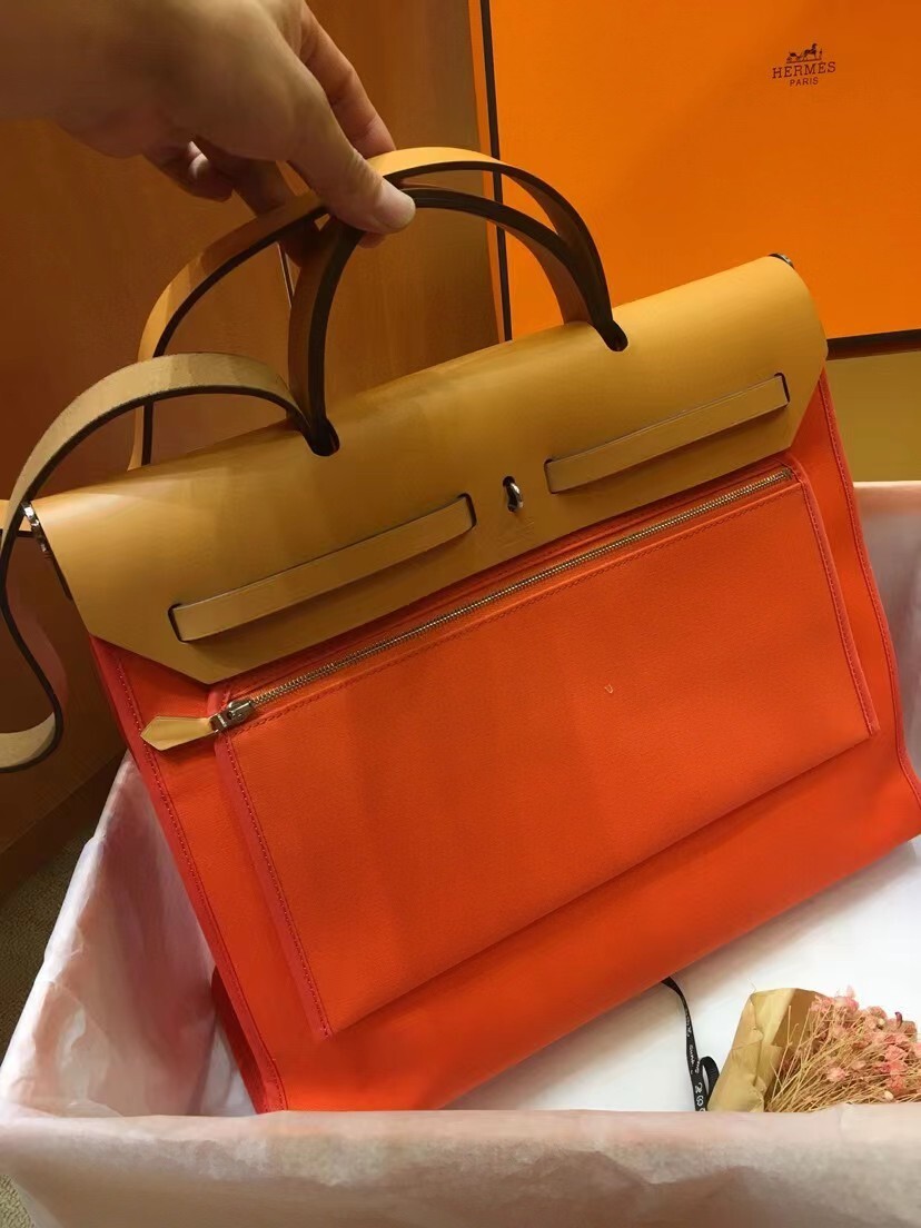 Hermes Herbag Zip 31 bag in orange canvas with a natural Vache Hunter leather flap and handle