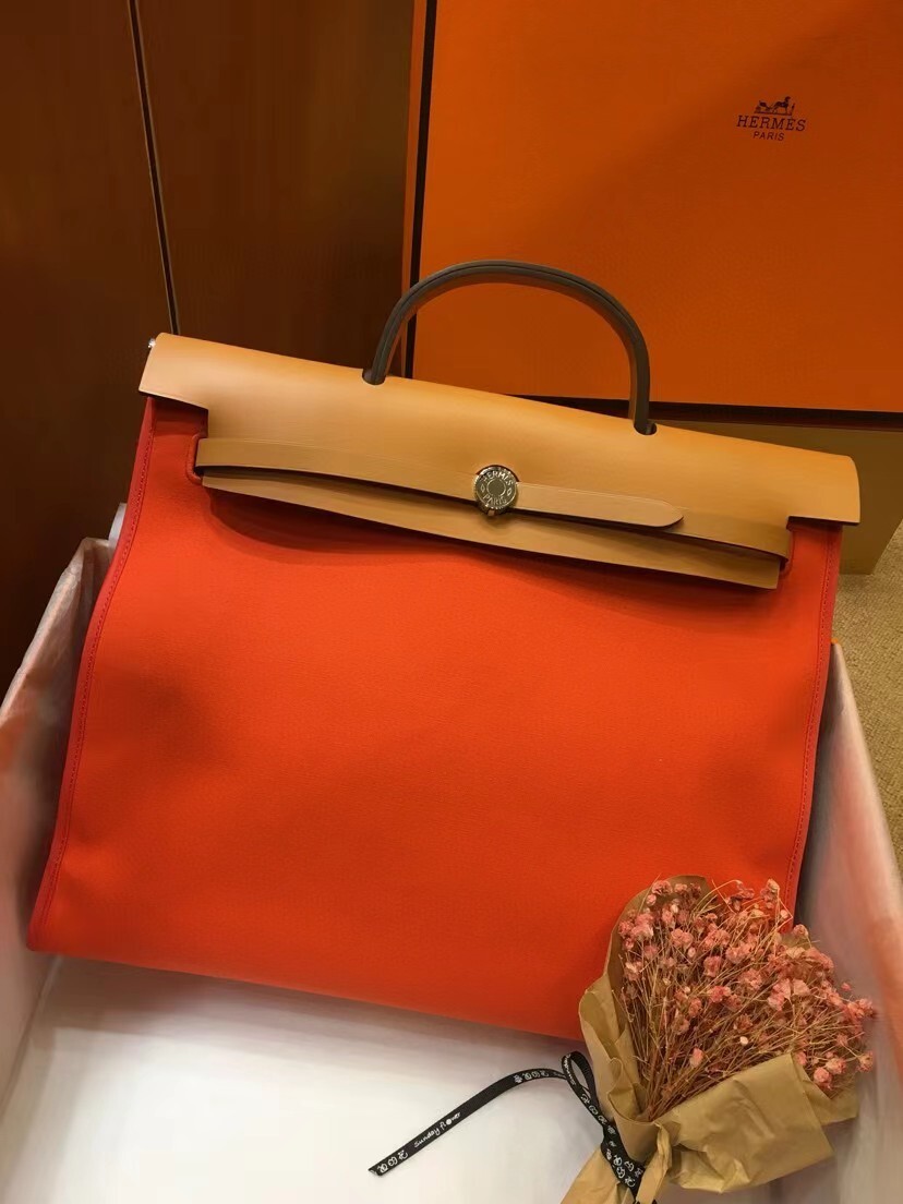 Hermes Herbag Zip 31 bag in orange canvas with a natural Vache Hunter leather flap and handle