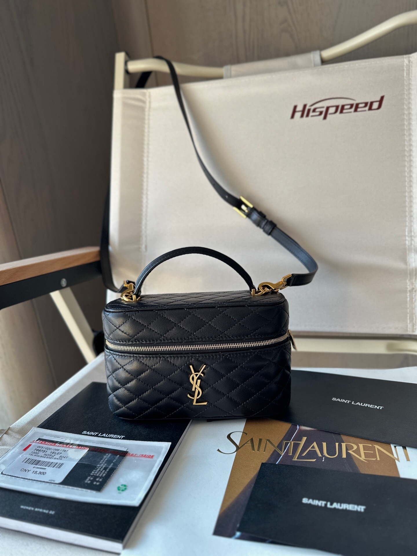 Saint Laurent Gaby Vanity Bag in black quilted lambskin leather with a top handle and a detachable strap.