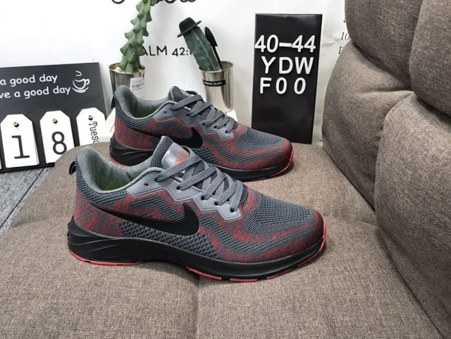 Nike running shoes with a grey and red pattern