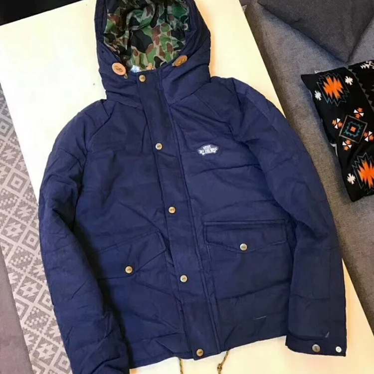 men's navy blue puffer jacket with a camouflage-lined hood