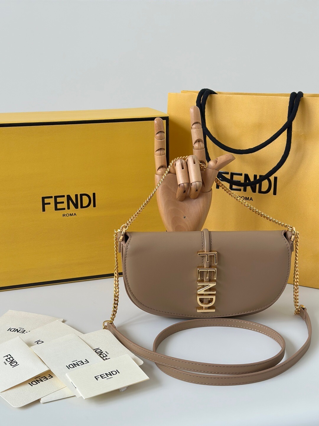 Fendi Fendigraphy wallet on chain in a camelia or beige-colored leather with gold-finish metalware.