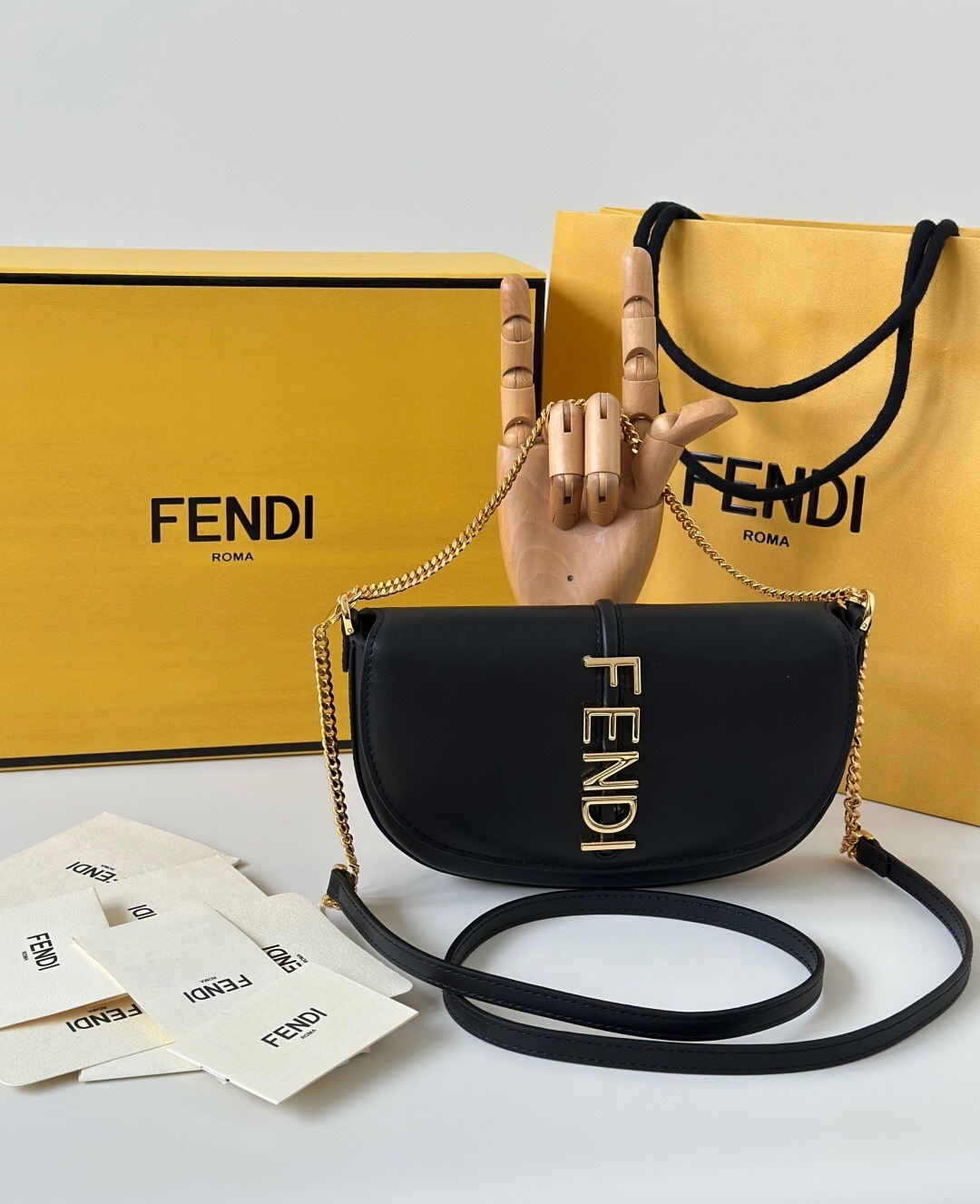 Fendi Fendigraphy black leather shoulder bag with a gold chain strap