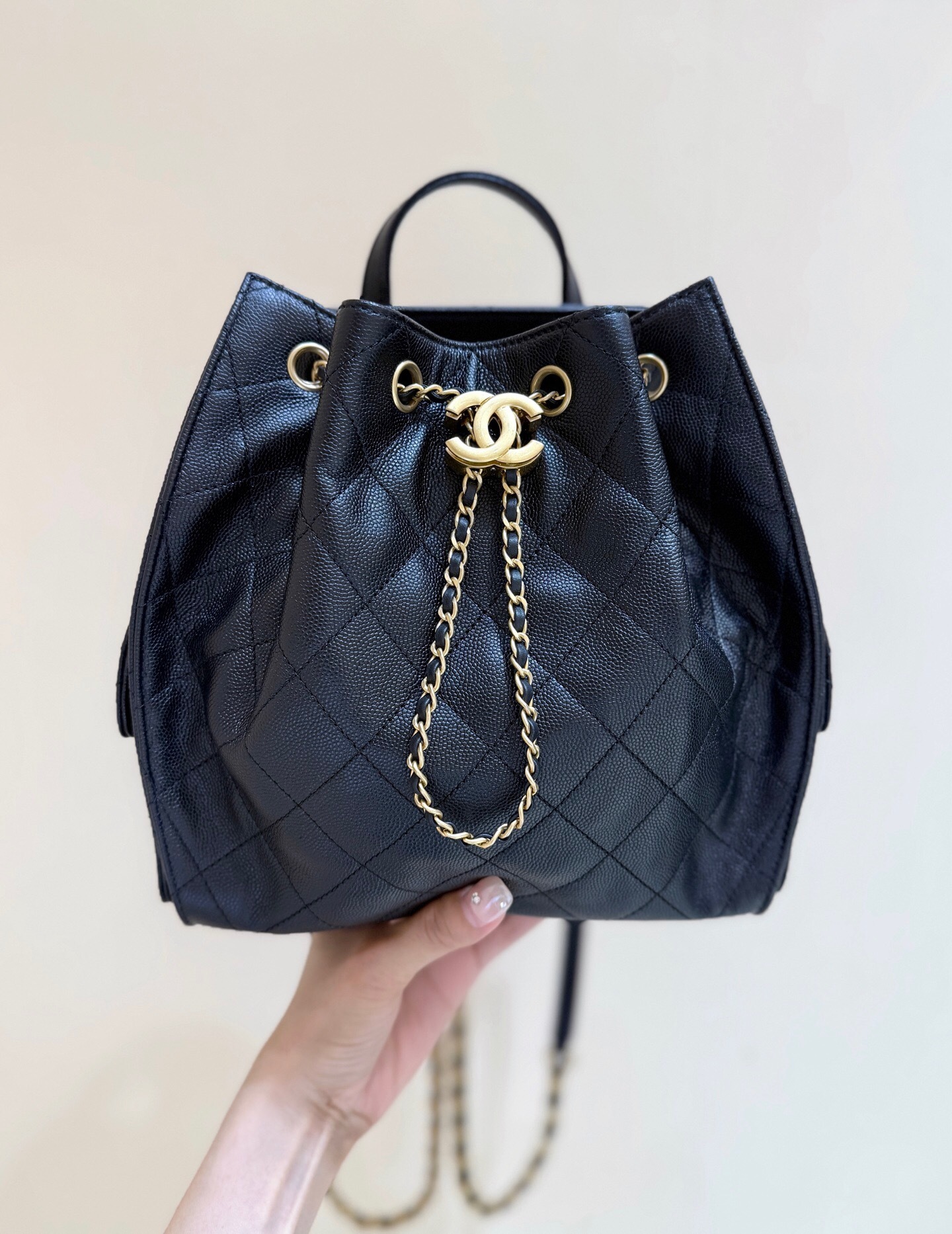 Chanel 25 backpack in black grained calfskin leather with gold-tone metal hardware