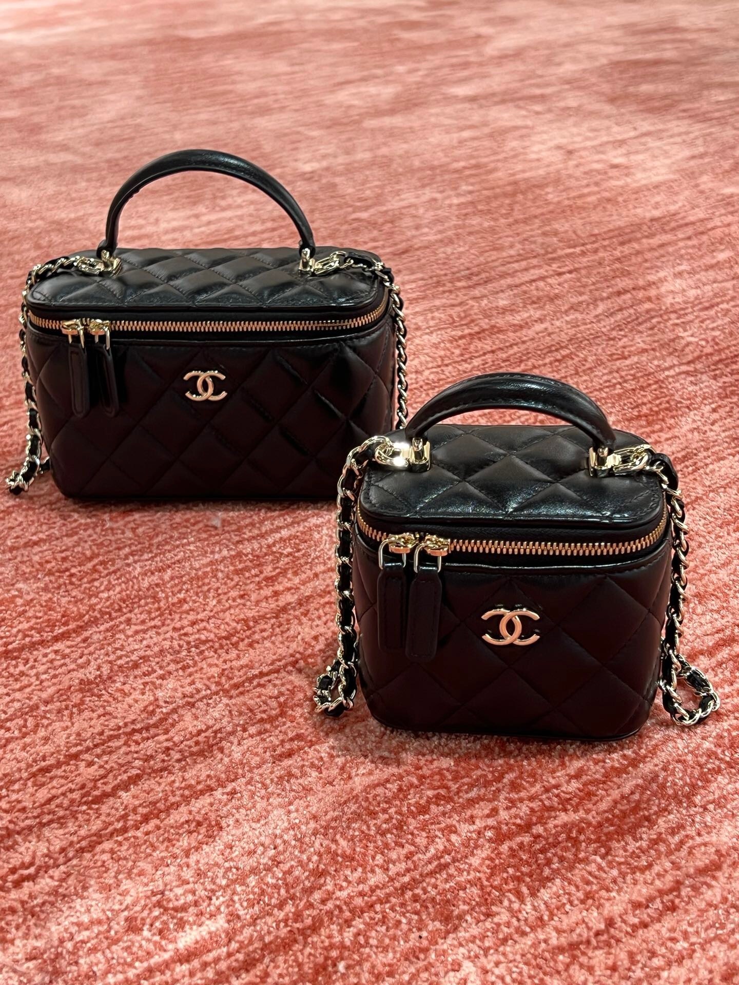 Chanel Small and big Top Handle Vanity Case in black quilted leather.