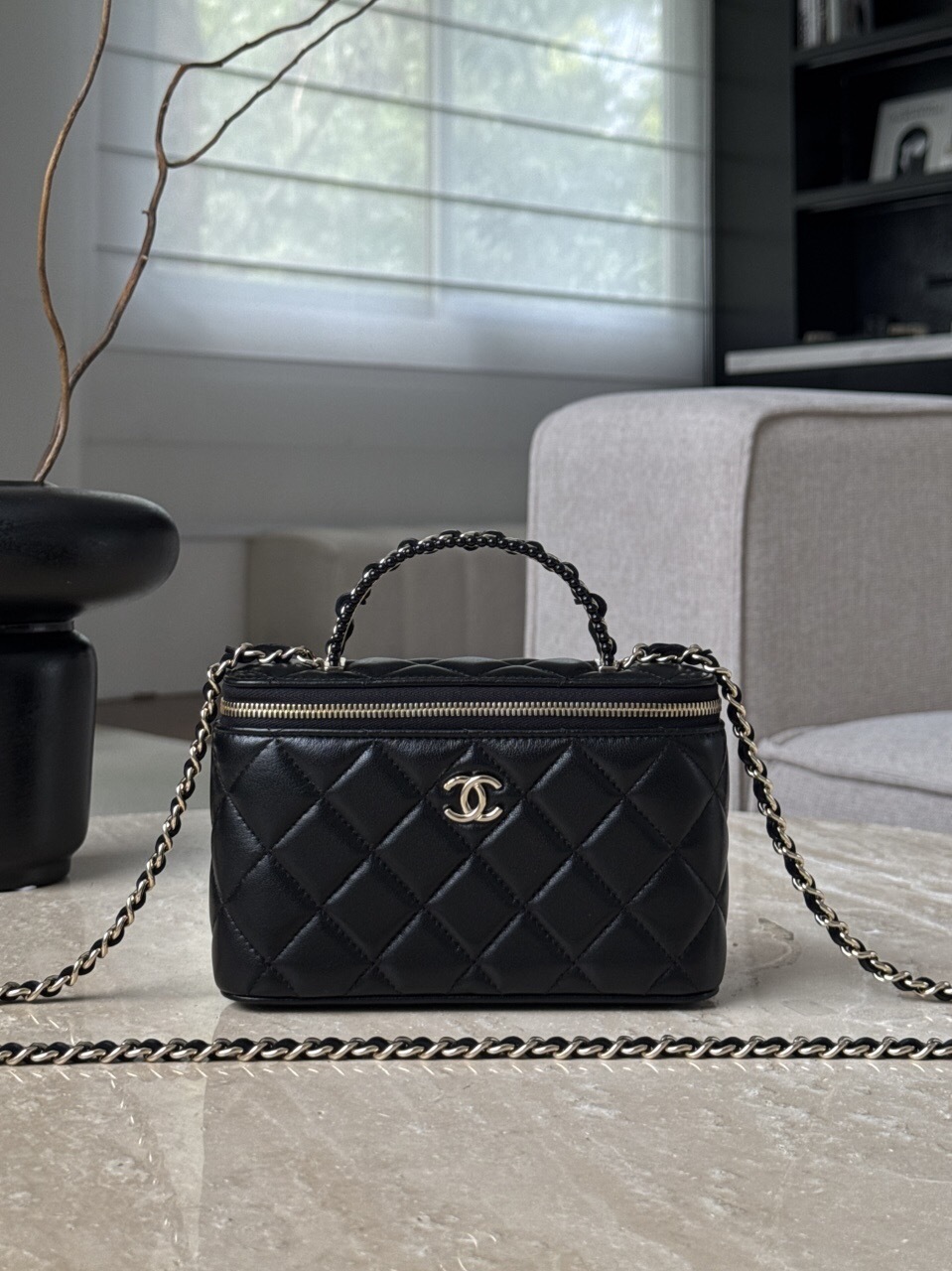 Chanel Small Top Handle Vanity Case in black quilted lambskin leather with a chain strap