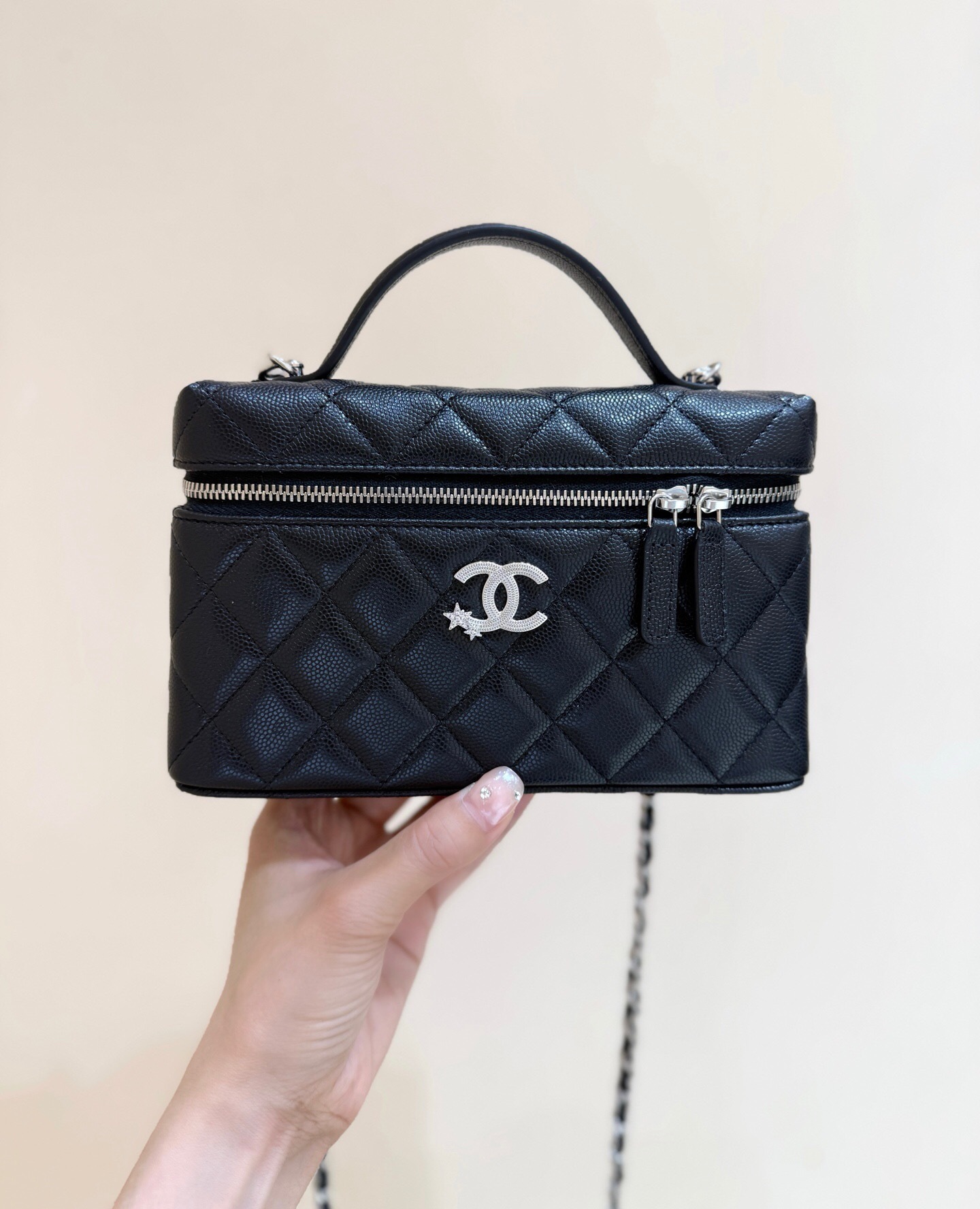 Chanel Vanity Bag with a top handle and shoulder strap in black leather with silver metal hardware