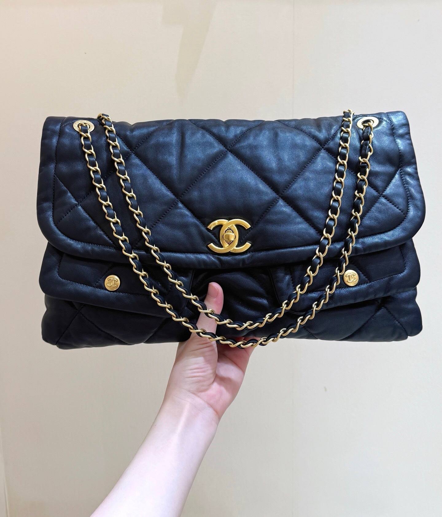 Chanel 25 handbag crafted from black quilted leather with a chain-link strap