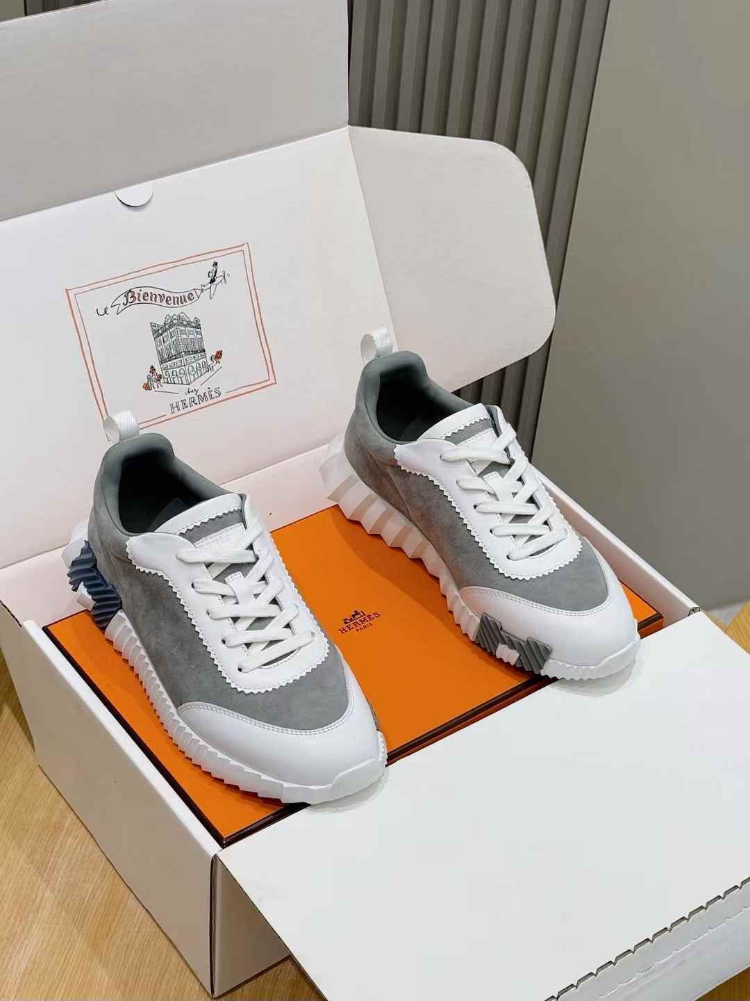 Hermes Bouncing sneakers in a black, white, and grey colorway.