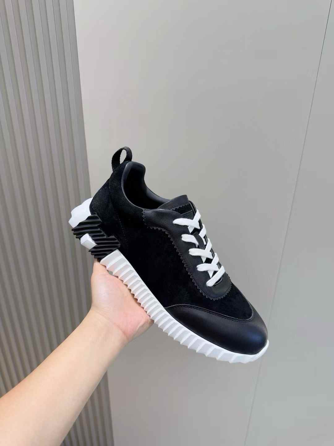 Hermès Bouncing sneaker in black and white, made of goatskin and suede goatskin leather with a white rubber sole