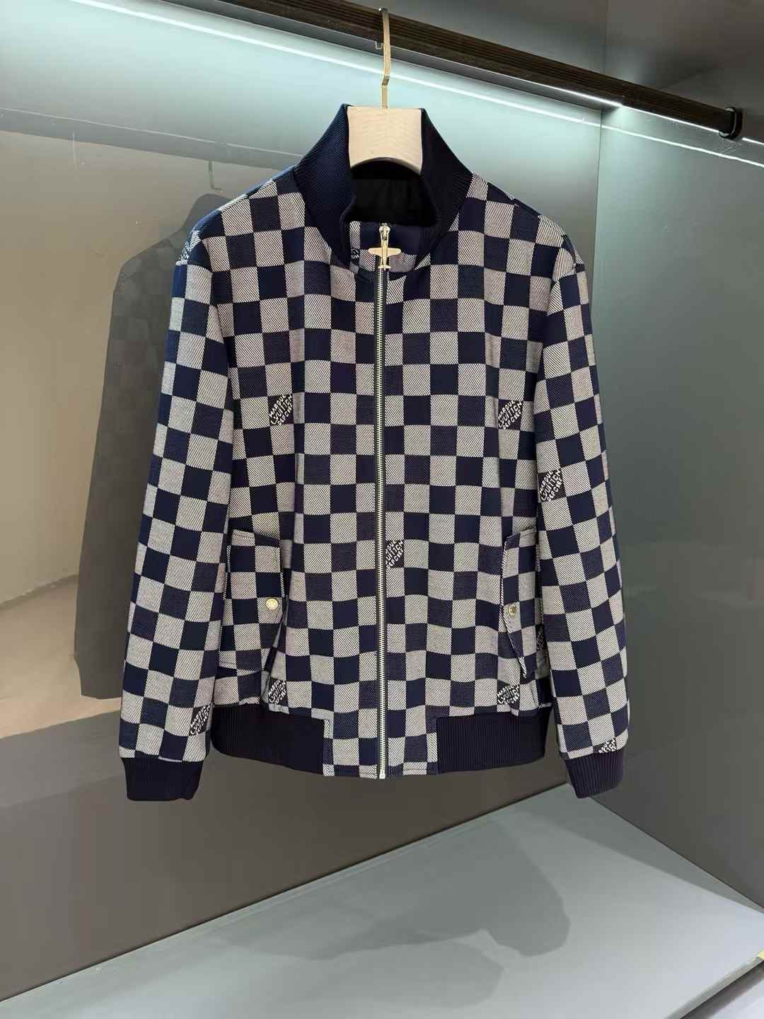 LV bomber jacket with a checkered pattern and the brand's logo
