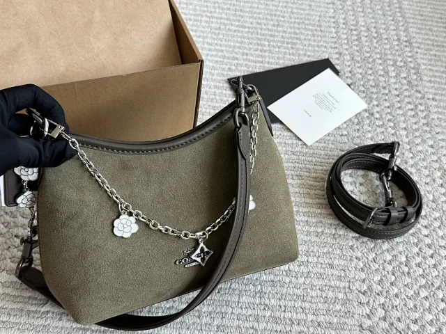 Coach hobo bag in suede with a chain strap and charms