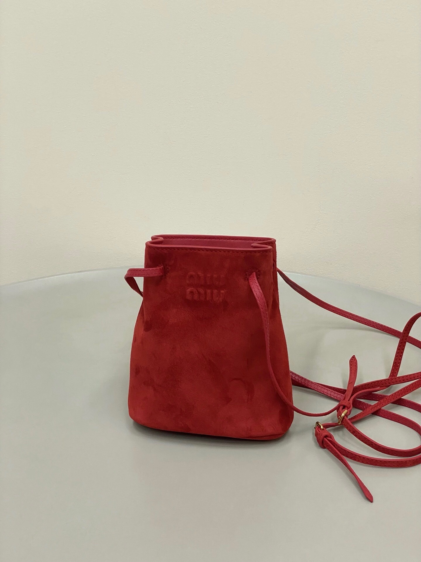 Miu Miu red suede drawstring bucket bag