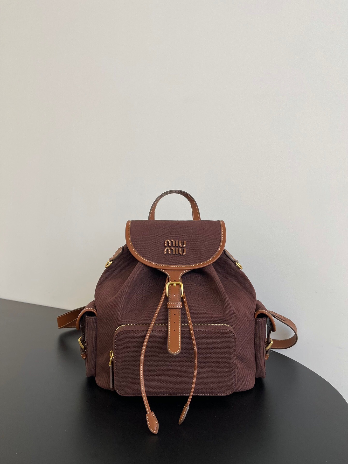 Miu Miu leather-trimmed flap backpack in brown canvas and leather