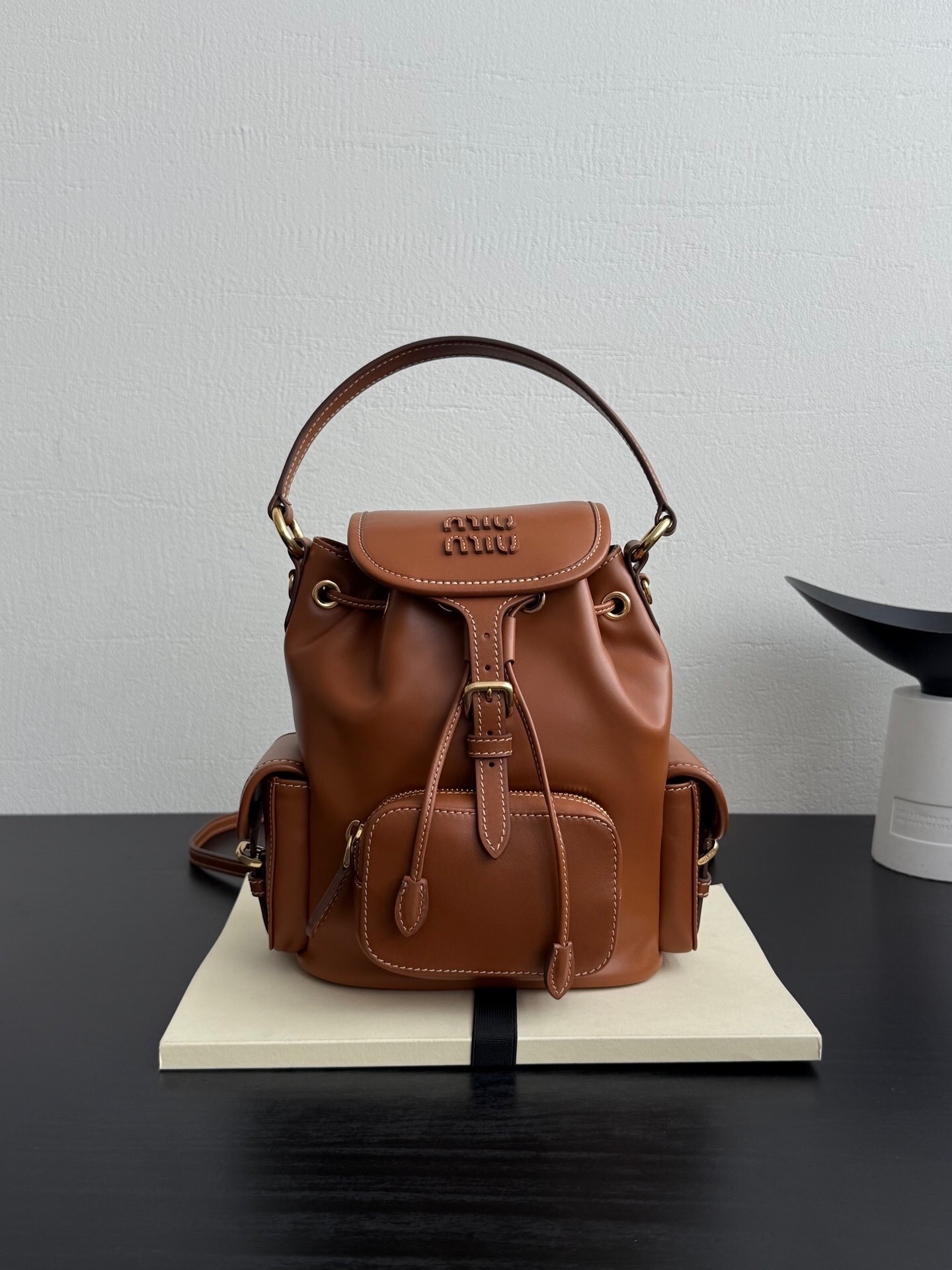 Miu Miu leather backpack with a buckle fastening and adjustable shoulder straps