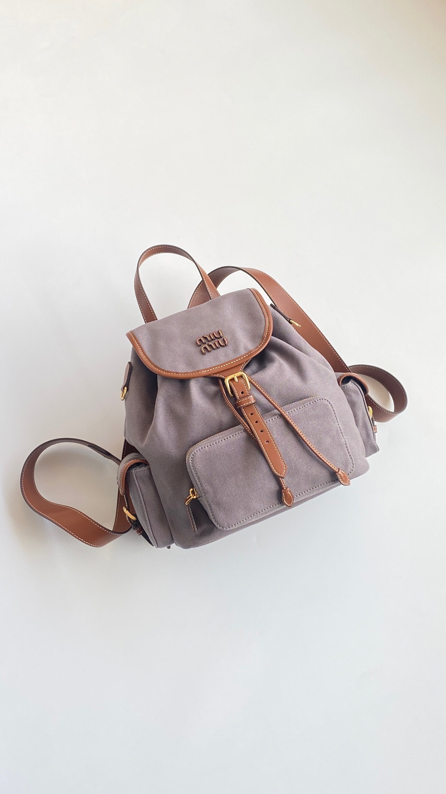 Miu Miu leather-trimmed flap backpack in grey canvas and leather