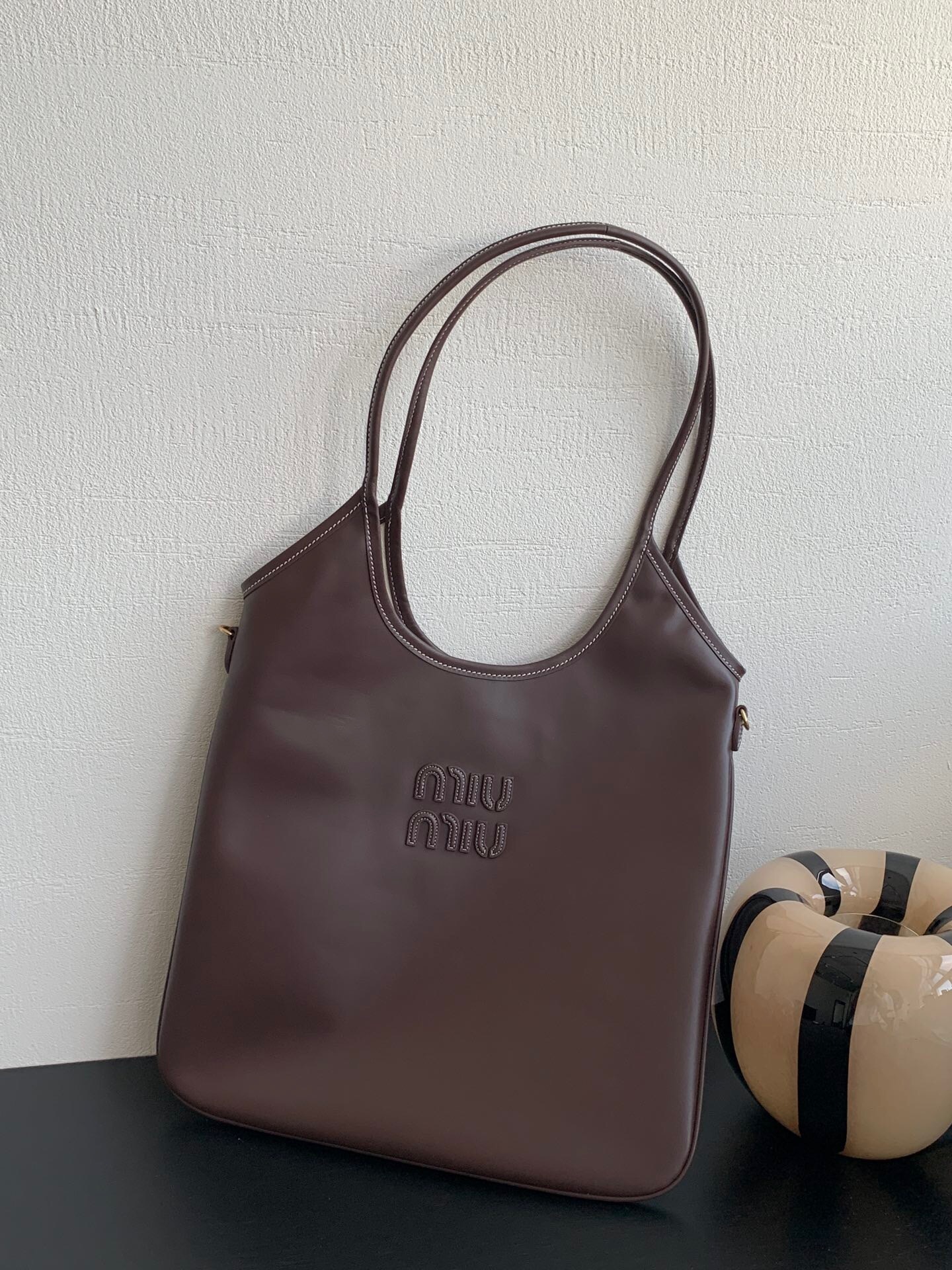 Miu Miu Ivy leather tote bag in a brown or coffee color