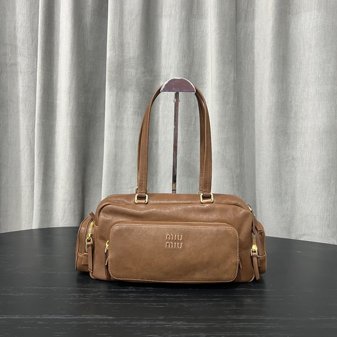 Miu Miu Pocket leather tote bag in a brown or tan color