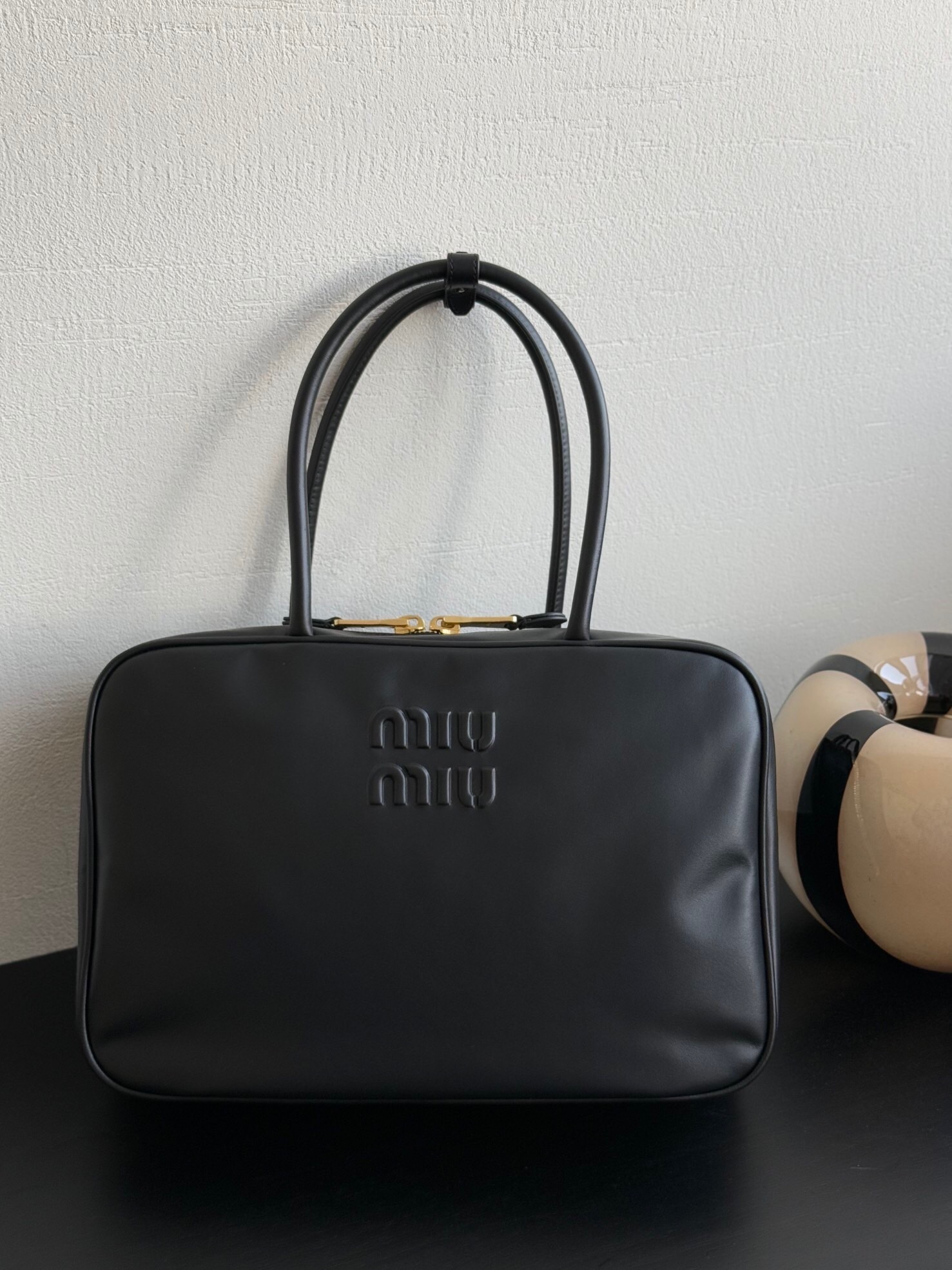 Miu Miu Beau leather bag with a debossed logo on the front