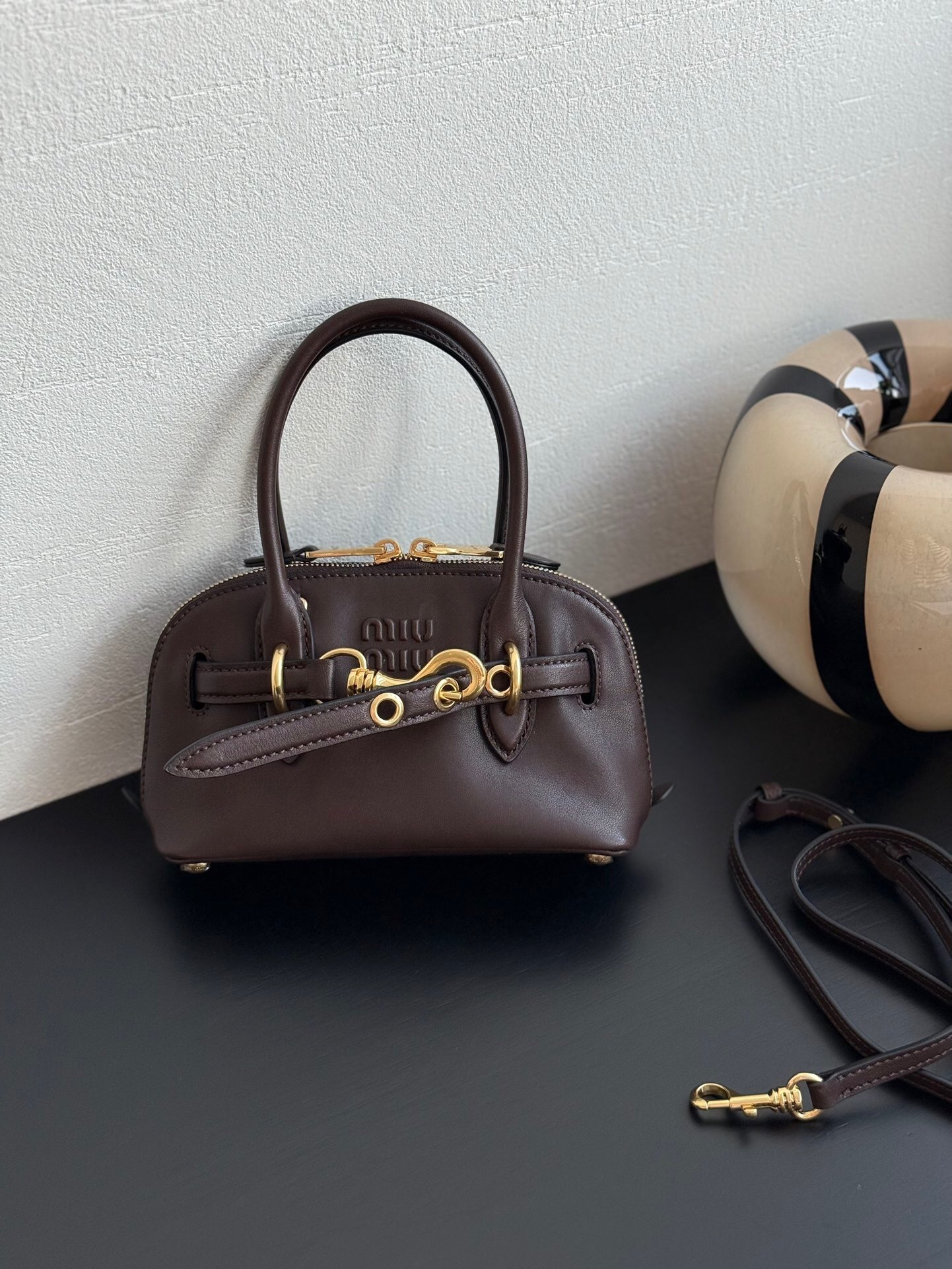 Miu Miu Aventure Nappa leather top-handle bag in a brown or oak color