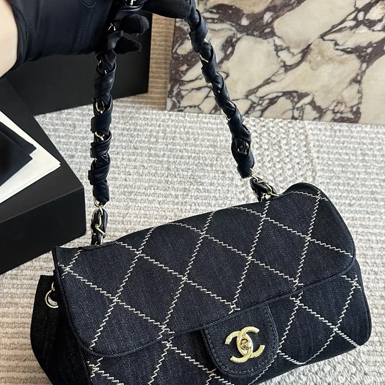 Chanel Classic Flap bag in quilted blue denim with gold-tone hardware and white contrast stitching`