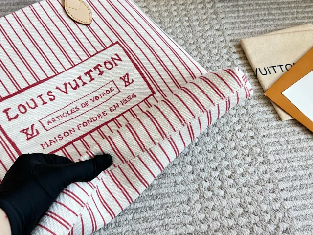 LV Carry It tote bag in a red and white striped canvas