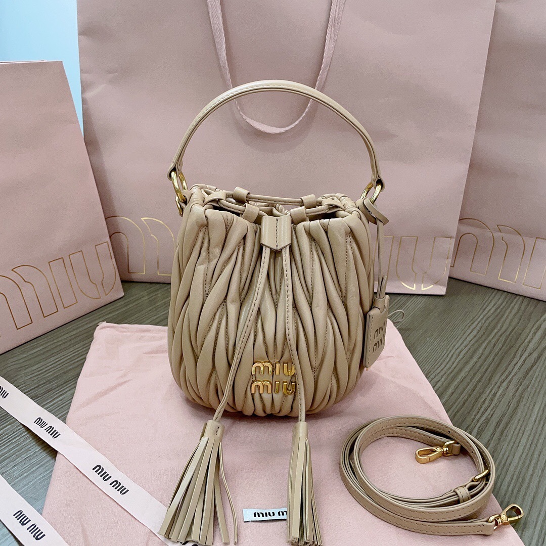 Miu Miu Matelassé nappa leather bucket bag in a cameo beige color