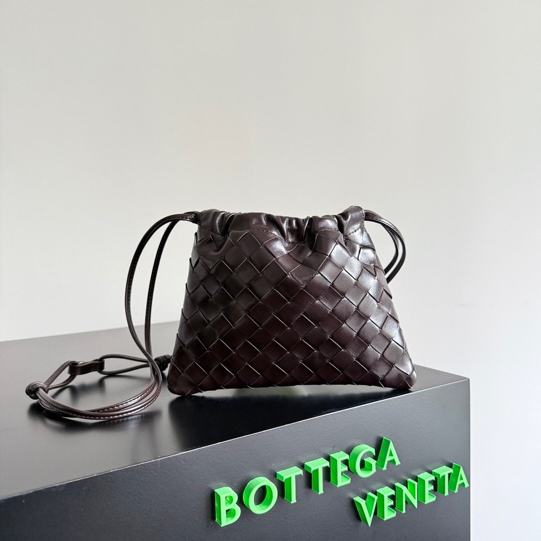 Bottega Veneta leather drawstring pouch in a dark brown color, featuring the brand's signature Intrecciato woven design