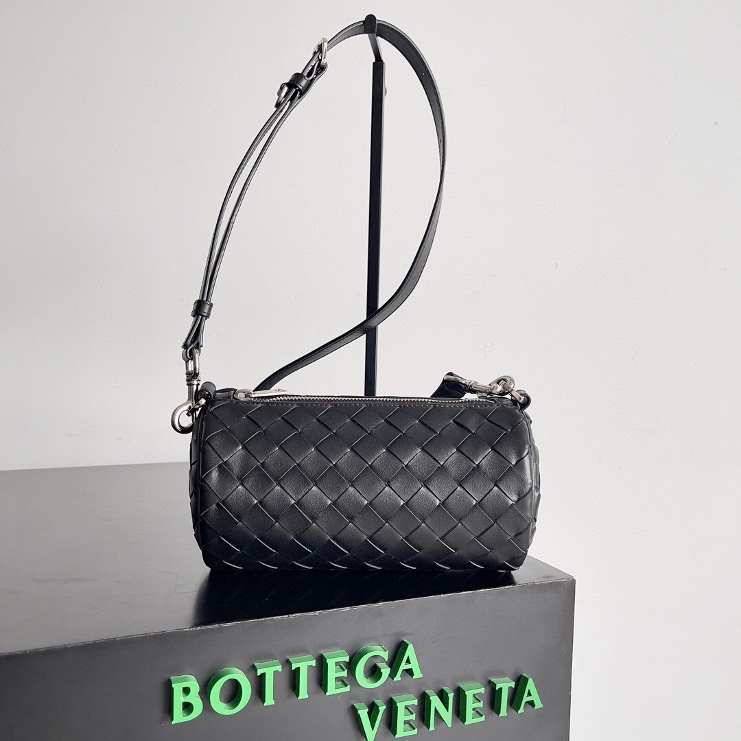Bottega Veneta Barrel Bag in black intrecciato woven leather.